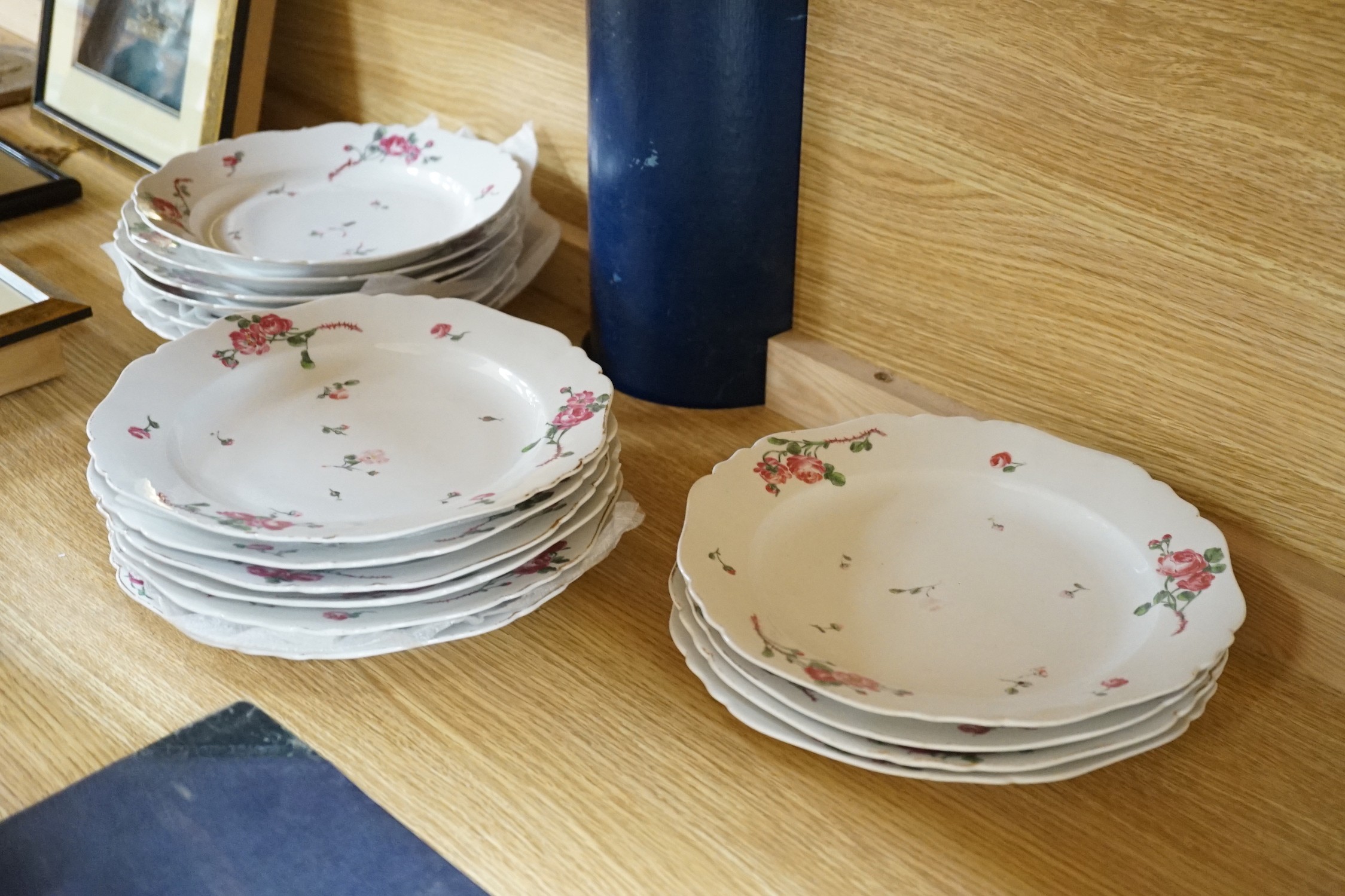 Seventeen late 18th century Continental porcelain rose painted plates 24cm